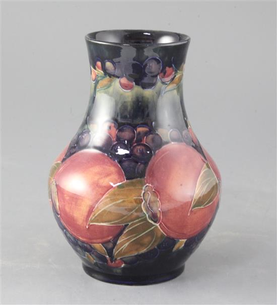 A Moorcroft pomegranate pattern baluster vase, height 6.75in.